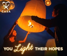 CASA Volunteer IMage with outdoor balloon lantern and 2 people